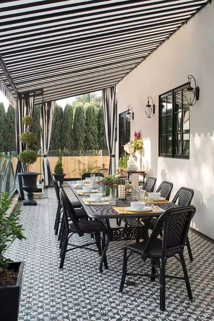 Custom Sunbrella outdoor drapery panels framing a covered patio dining area
