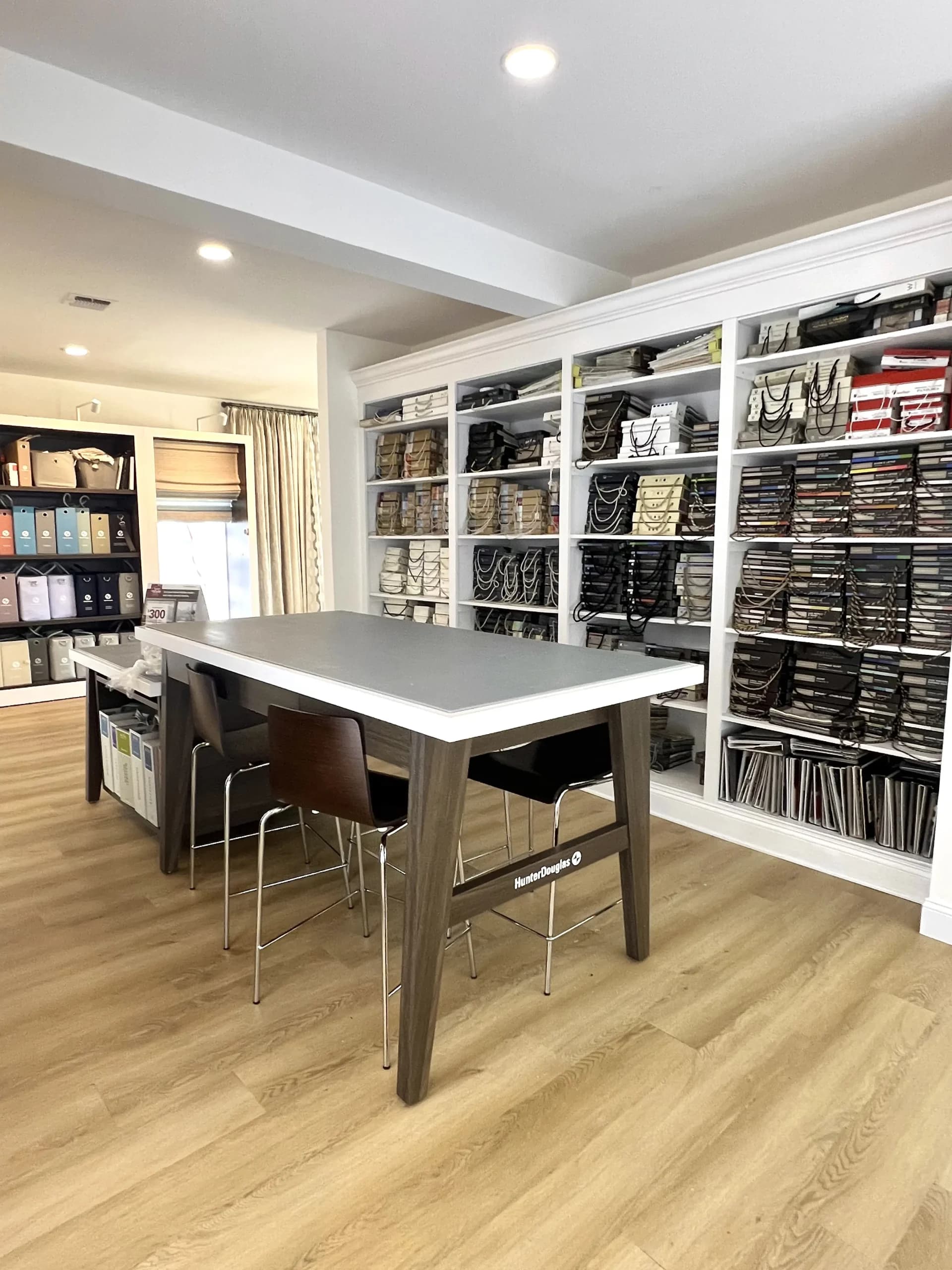 The Homestead Window Treatments design studio, with the Hunter Douglas consultation table and the full fabric and hardware library