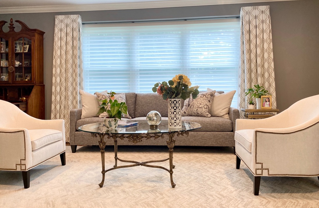 Living room window treatments with layered drapery and sheer shades in an Albertson, NY home