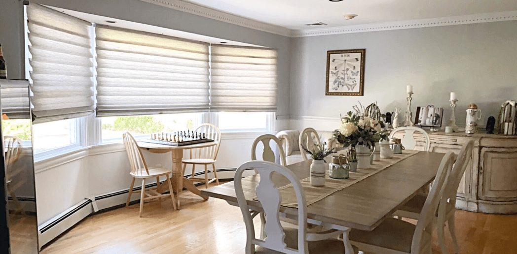 Hunter Douglas shades filtering sunlight in a Hempstead NY dining room