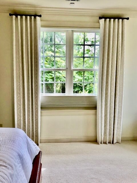 Elegant custom thermal draperies in a Hamptons bedroom designed for warmth and energy efficiency during winter.