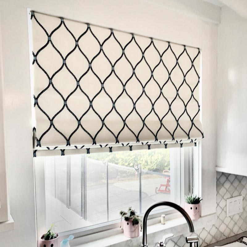 Custom Roman shade in a Long Island kitchen featuring a patterned fabric for light control and modern style.
