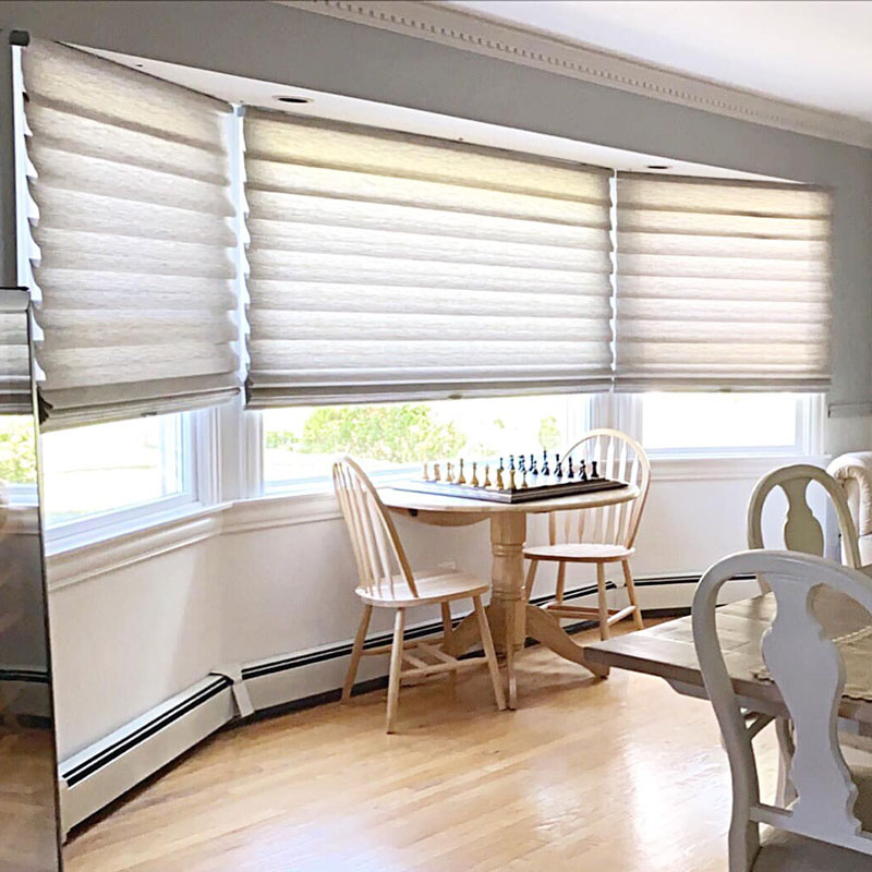 Hunter Douglas Blinds in a Bright Long Island Dining Room Hunter Douglas blinds on a bright Long Island dining area window with natural wood chairs