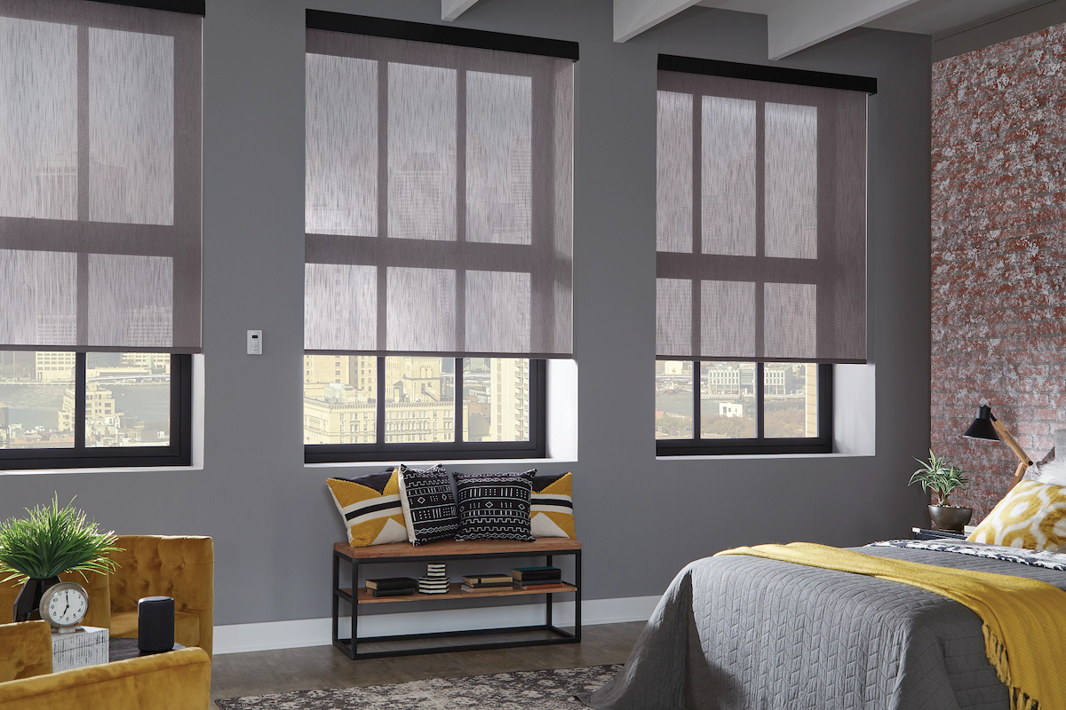 Modern Long Island bedroom with gray solar shades filtering natural light