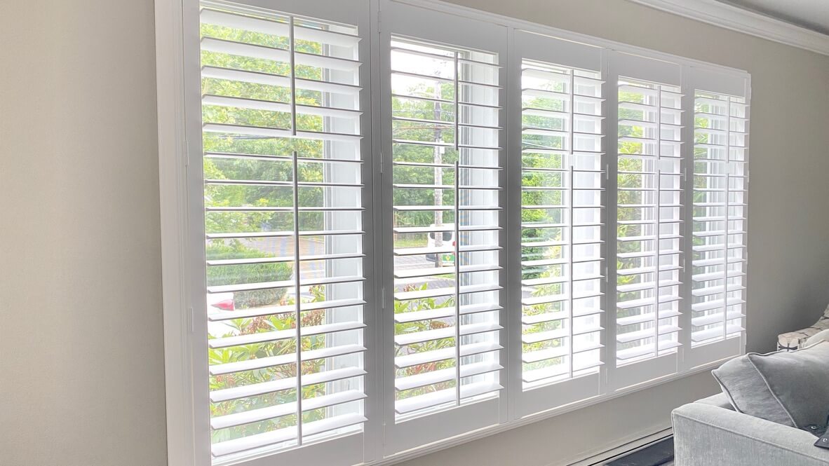 Close-up of Hunter Douglas window plantation shutters in a bright Long Island home interior.
