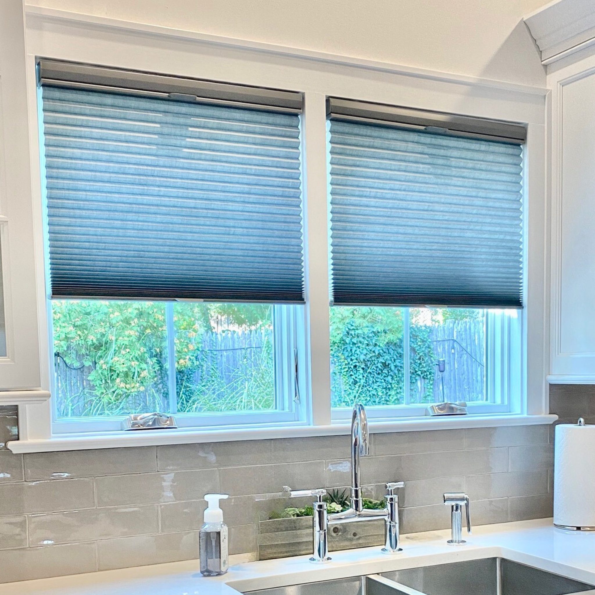Cellular Shades for Modern Kitchen Windows in Long Island, NY Modern kitchen sink area with cellular shades providing light control and privacy, Long Island, NY.